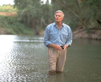 Heston wades the River Jordan