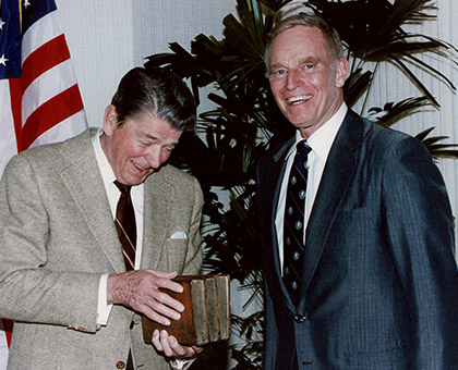 Charlton Heston with Reagan holding books